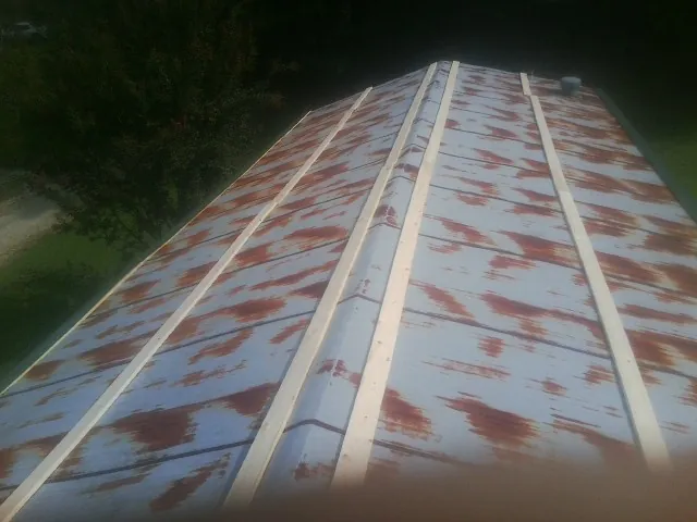 Rusted metal roof panels with new wood purlins before replacement — Storm Damage Roof Repair in Mcintosh by Roofing Brothers